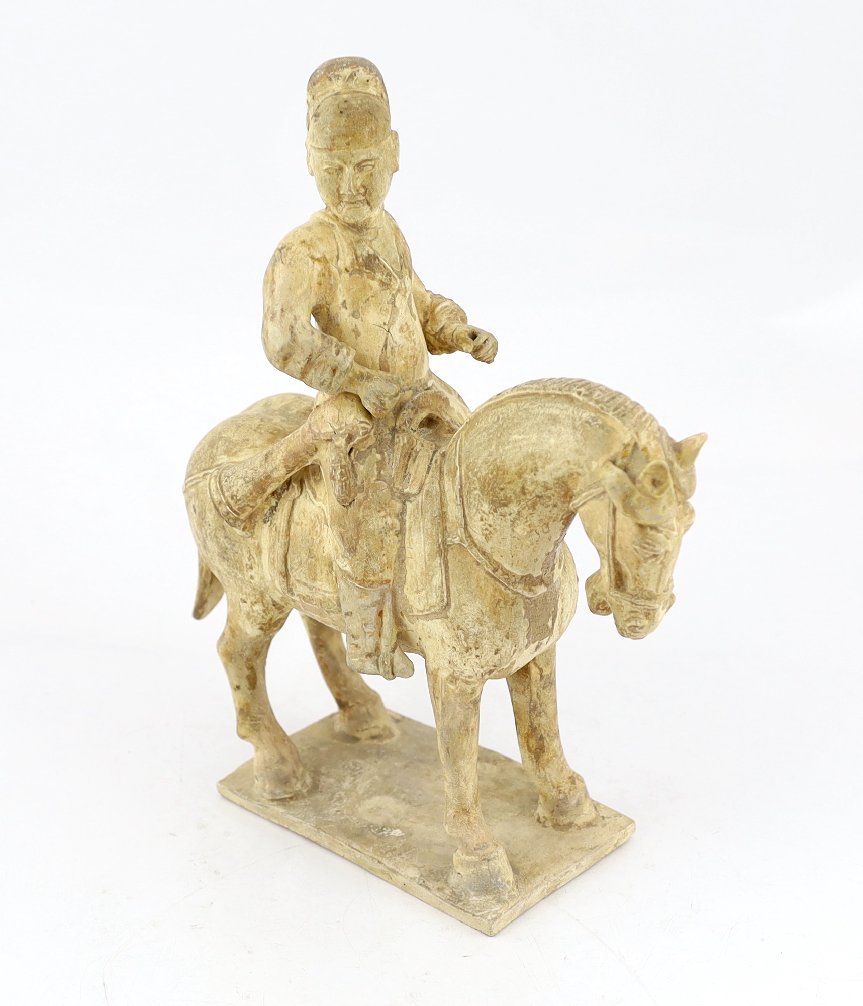 A Chinese cream glazed pottery model of an archer on horseback, Tang Dynasty (618-906 AD)